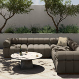 A modern take on mid-century Italian design, soft volume and exaggerated proportions fuse for a sculpted look and playful feel. Atop a plinth-style teak base, outdoor-friendly five-piece sectional features dramatic tufting for a padded sit, indoors and out. Amethyst Home provides interior design, new home construction design consulting, vintage area rugs, and lighting in the Boston metro area.