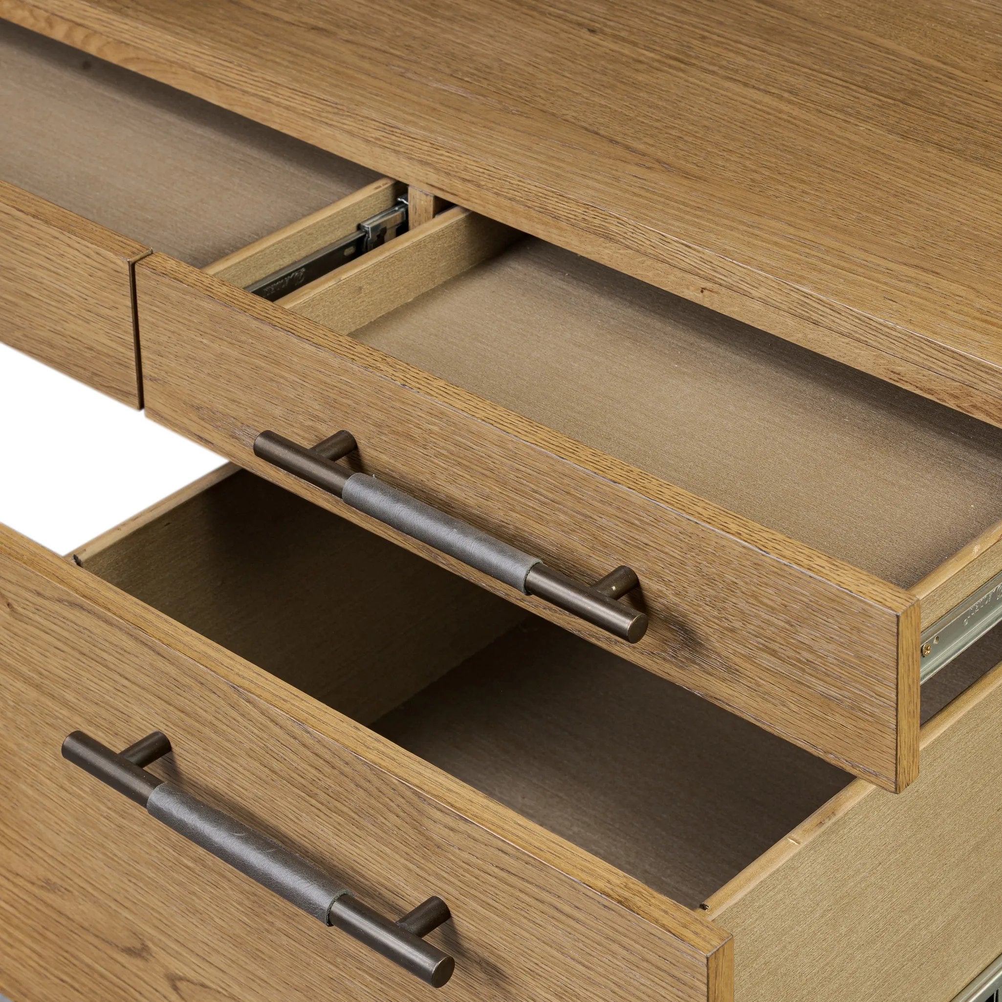 Amber-finished oak crafts shapes a clean silhouette, accented with iron hardware wrapped in black top-grain leather. Vary-sized drawers offer plenty of storage, while outset legs bring a design-forward touch Amethyst Home provides interior design, new home construction design consulting, vintage area rugs, and lighting in the Laguna Beach metro area.