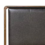Amber-finished solid oak frames a floating, sling-style headboard made from black top-grain leather, with subtly rounded edges and metal dowel detailing Amethyst Home provides interior design, new home construction design consulting, vintage area rugs, and lighting in the Austin metro area.