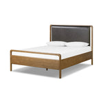 Amber-finished solid oak frames a floating, sling-style headboard made from black top-grain leather, with subtly rounded edges and metal dowel detailing Amethyst Home provides interior design, new home construction design consulting, vintage area rugs, and lighting in the Des Moines metro area.