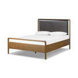 Amber-finished solid oak frames a floating, sling-style headboard made from black top-grain leather, with subtly rounded edges and metal dowel detailing Amethyst Home provides interior design, new home construction design consulting, vintage area rugs, and lighting in the Des Moines metro area.