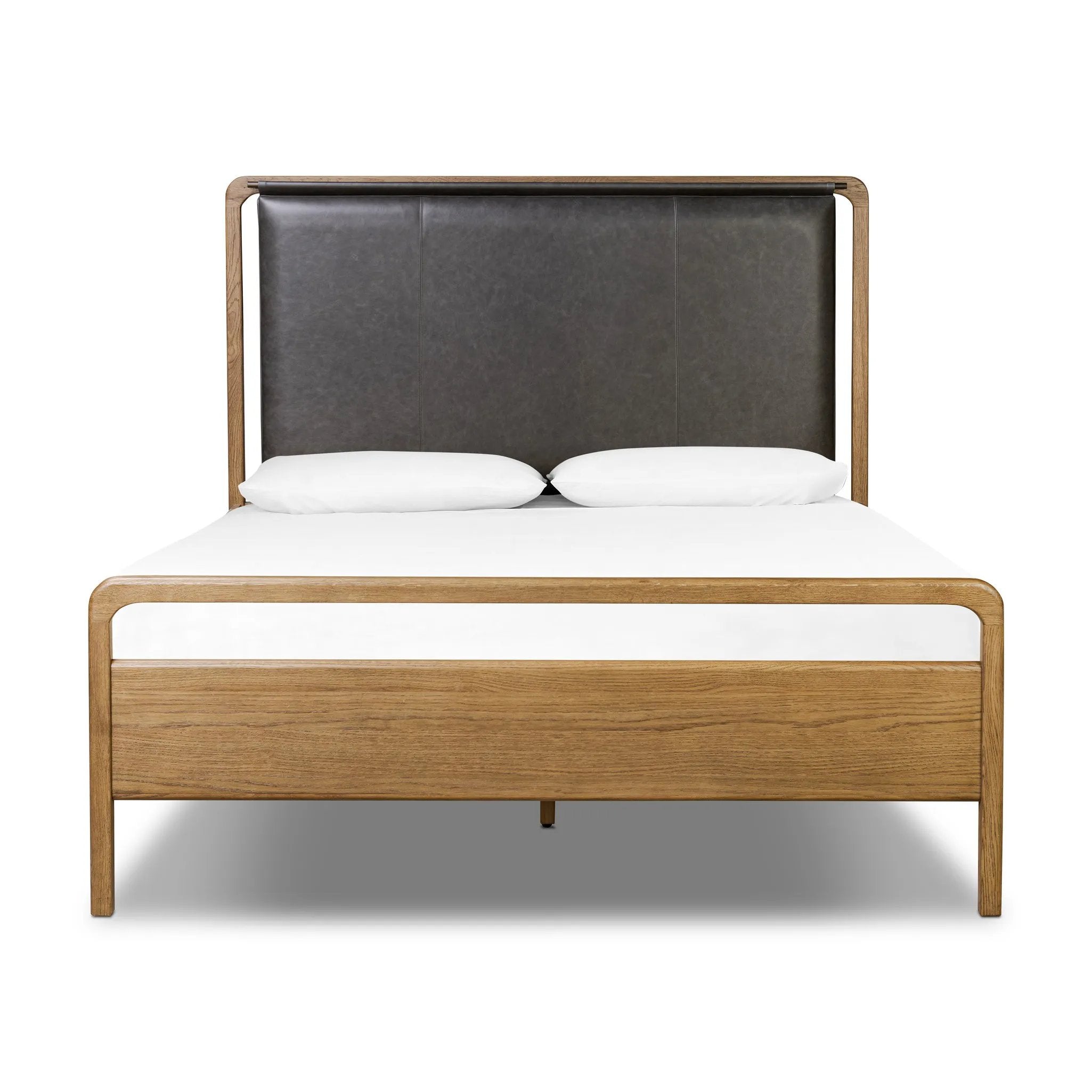 Amber-finished solid oak frames a floating, sling-style headboard made from black top-grain leather, with subtly rounded edges and metal dowel detailing Amethyst Home provides interior design, new home construction design consulting, vintage area rugs, and lighting in the Nashville metro area.