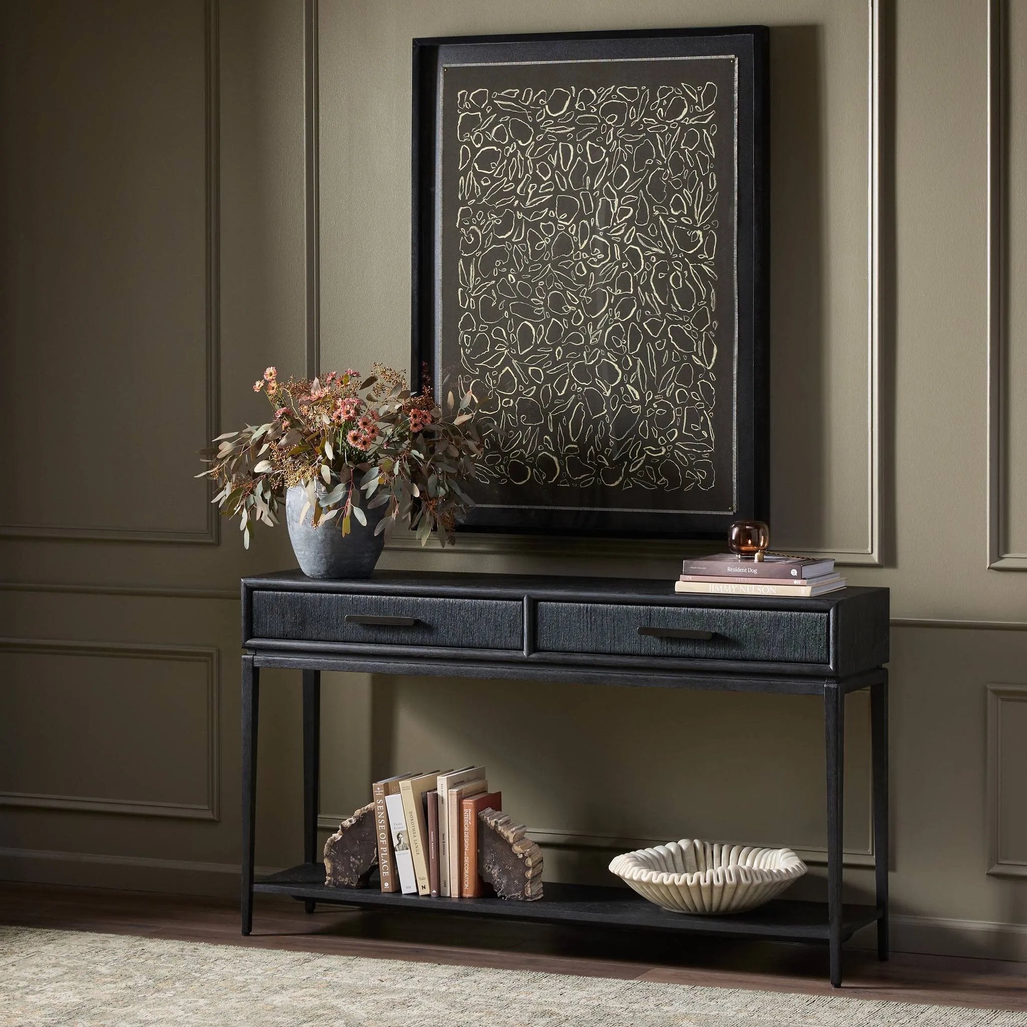 Featuring Rosenell Black Oak Veneer Console Table 60" by Four Hands at Amethyst Home. Elevate your living space or media room with a slim-profile console of black-finished oak. A smooth top pairs with two drawers covered with woven paper cord, while lower open shelving creates bonus storage and display options. The result: a dark, Scandinavian-inspired look th. Amethyst Home provides interior design, new home construction design consulting, vintage area rugs, and lighting in the Dallas metro area.