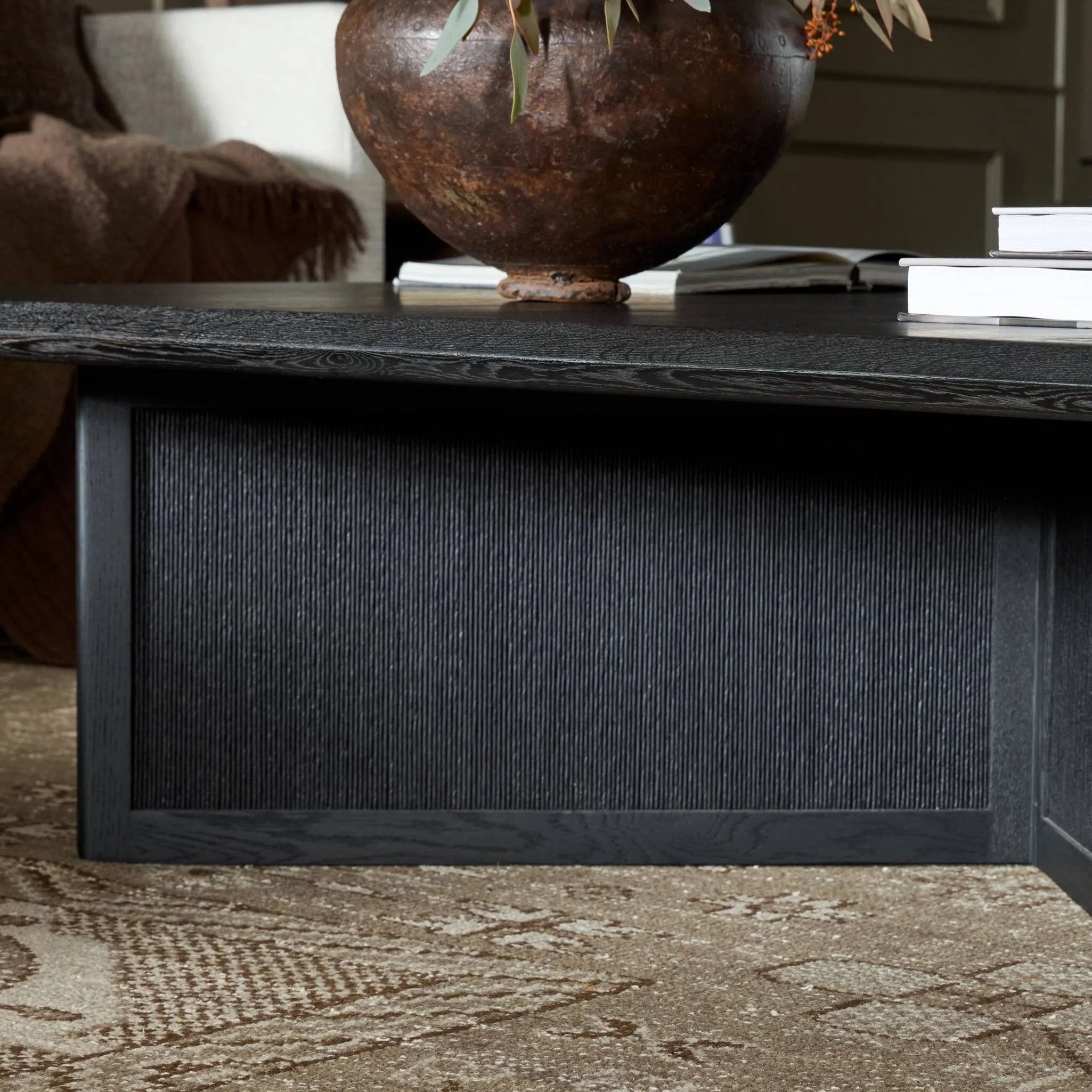 Featuring Rosenell Black Oak Veneer Square Coffee Table by Four Hands at Amethyst Home. Anchor your living space with a squared coffee table of black-finished oak. A smooth top pairs with a panel-style base of woven paper cord for a rich, clean look that will work into your collection beautifully. Overall Dimensions: 55.00"w x 55.00"d x 15.00"h. Amethyst Home provides interior design, new home construction design consulting, vintage area rugs, and lighting in the Miami metro area.