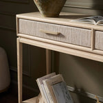 Featuring Rosenell Natural Oak Veneer Console Table 60" by Four Hands at Amethyst Home. Elevate your living space or media room with a slim-profile console of light, natural oak. A smooth top pairs with two drawers covered with woven paper cord, while lower open shelving creates bonus storage and display options. The result: a clean, Scandinavian-inspire. Amethyst Home provides interior design, new home construction design consulting, vintage area rugs, and lighting in the Laguna Beach metro area.
