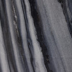 Precise curves add up to modern presence. Bold ebony marble is carved from a single piece of stone and turned on a lathe to form the curves and angles of this end table Amethyst Home provides interior design, new home construction design consulting, vintage area rugs, and lighting in the Dallas metro area.