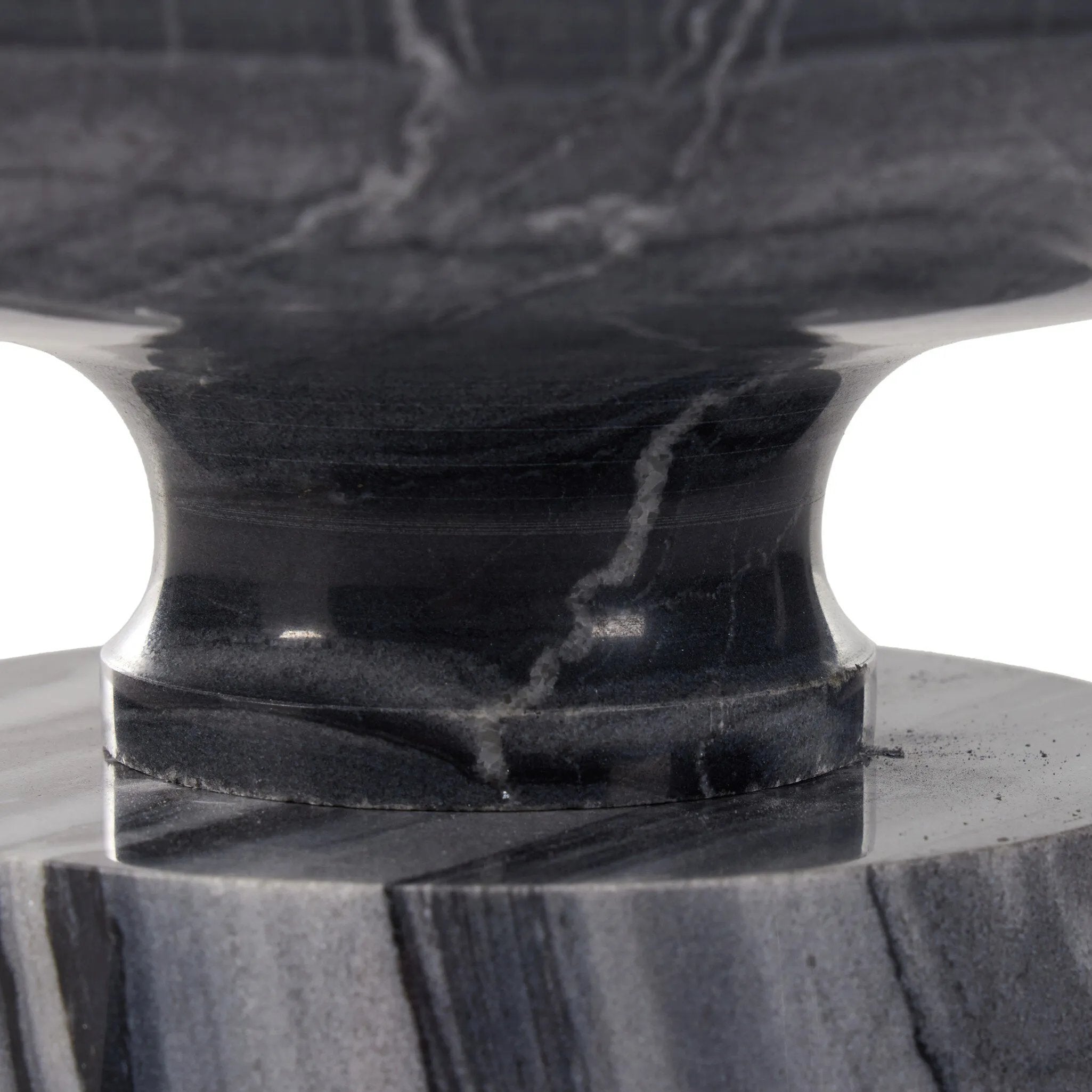 Precise curves add up to modern presence. Bold ebony marble is carved from a single piece of stone and turned on a lathe to form the curves and angles of this end table Amethyst Home provides interior design, new home construction design consulting, vintage area rugs, and lighting in the Laguna Beach metro area.