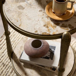 Featuring Ruthie Fossil Marble End Table by Four Hands at Amethyst Home. Work a heritage-inspired piece into your collection with a tiered end table of hammered iron in an aged brass. With inset marble shelves and turn-style legs, this table's fine details bring an elevated, artisan look to any space. Perfectly sized to keep your favorite book or drink on . Amethyst Home provides interior design, new home construction design consulting, vintage area rugs, and lighting in the Des Moines metro area.