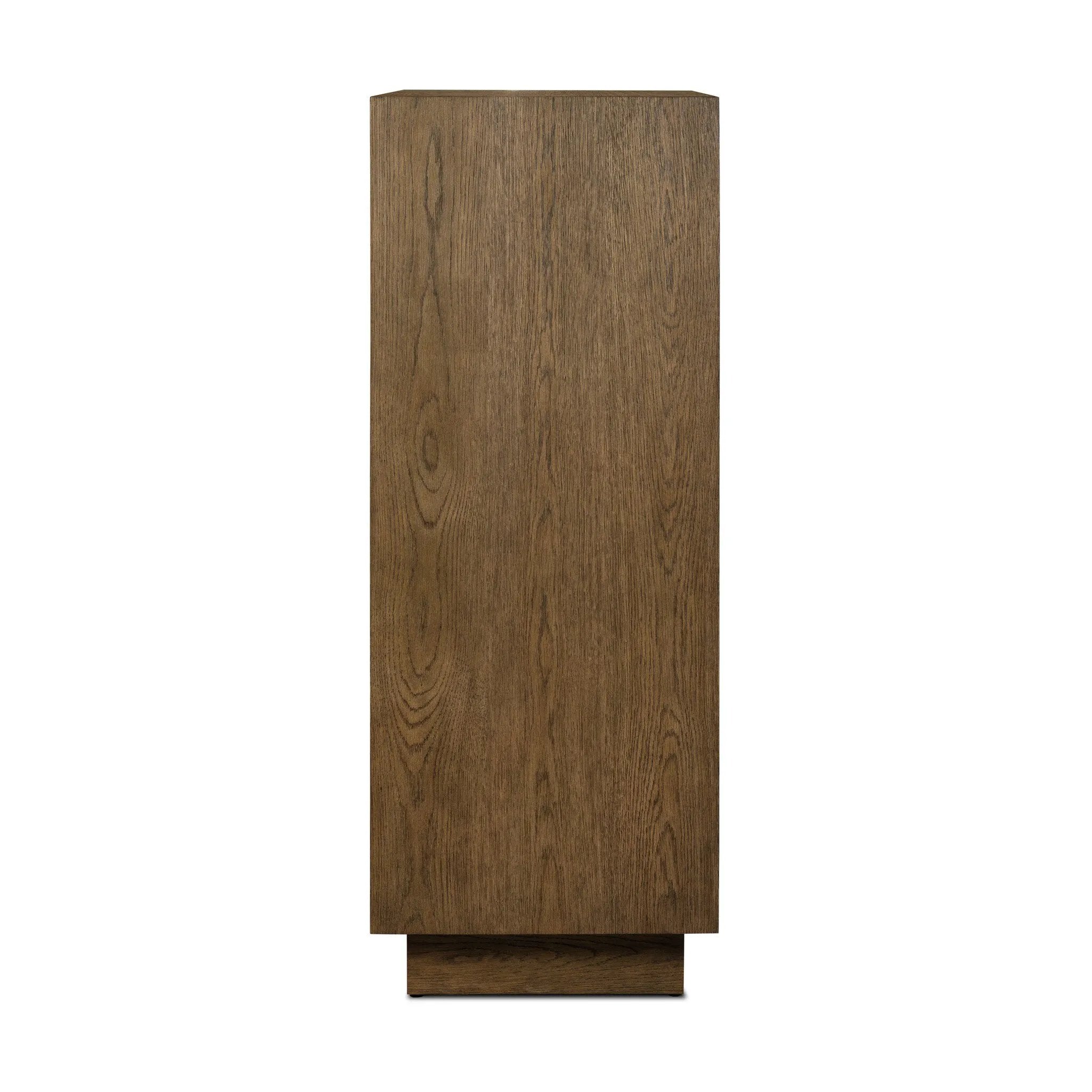 Grounding and stunning. We paired a modern frame and chunky base with door panels featuring oyster cuts of oak that take a specialized skill to create. Each cut captures the story of the wood and brings a natural, organic rhythm to the entire cabinet, and any space. Amethyst Home provides interior design, new home construction design consulting, vintage area rugs, and lighting in the Seattle metro area.