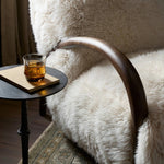 This versatile accent chair is upholstered in a faux Mongolian shearling with a textural high pile. A contrasting, chunky parawood frame hugs the seat and is wire-brushed for a warm, vintage feel Amethyst Home provides interior design, new home construction design consulting, vintage area rugs, and lighting in the Calabasas metro area.