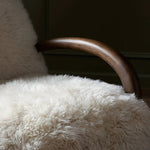 This versatile accent chair is upholstered in a faux Mongolian shearling with a textural high pile. A contrasting, chunky parawood frame hugs the seat and is wire-brushed for a warm, vintage feel Amethyst Home provides interior design, new home construction design consulting, vintage area rugs, and lighting in the Dallas metro area.
