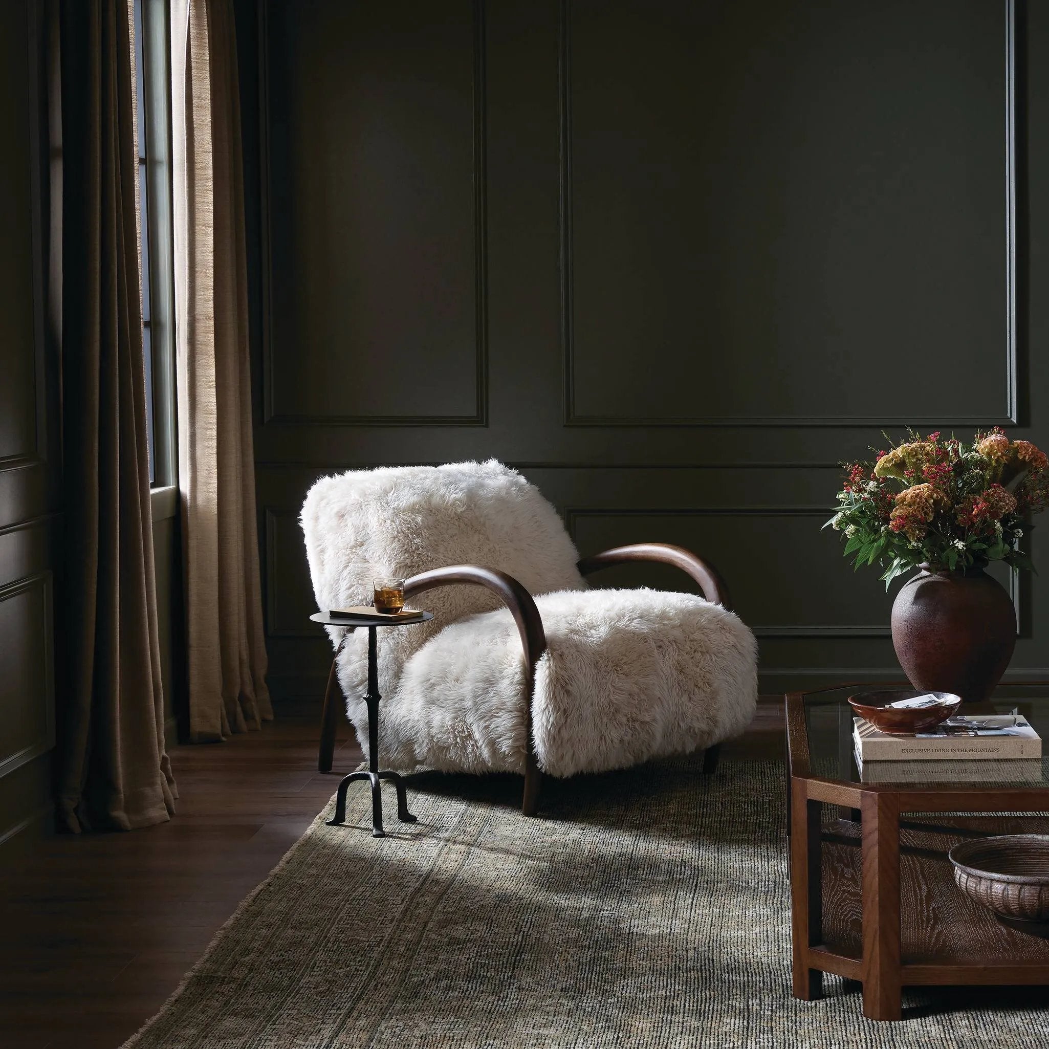 This versatile accent chair is upholstered in a faux Mongolian shearling with a textural high pile. A contrasting, chunky parawood frame hugs the seat and is wire-brushed for a warm, vintage feel Amethyst Home provides interior design, new home construction design consulting, vintage area rugs, and lighting in the Nashville metro area.