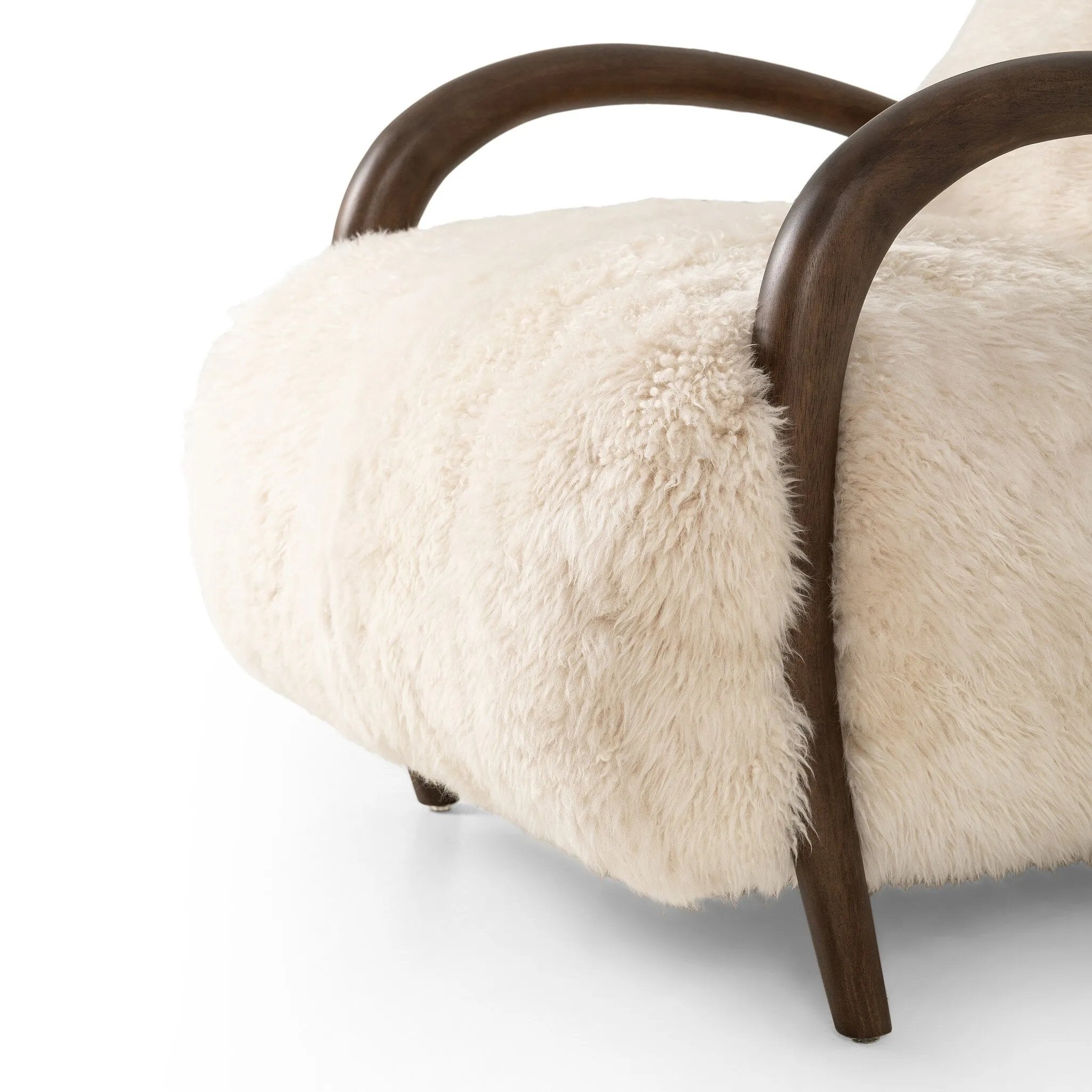 This versatile accent chair is upholstered in a faux Mongolian shearling with a textural high pile. A contrasting, chunky parawood frame hugs the seat and is wire-brushed for a warm, vintage feel Amethyst Home provides interior design, new home construction design consulting, vintage area rugs, and lighting in the Newport Beach metro area.