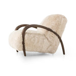 This versatile accent chair is upholstered in a faux Mongolian shearling with a textural high pile. A contrasting, chunky parawood frame hugs the seat and is wire-brushed for a warm, vintage feel Amethyst Home provides interior design, new home construction design consulting, vintage area rugs, and lighting in the Seattle metro area.