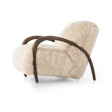 This versatile accent chair is upholstered in a faux Mongolian shearling with a textural high pile. A contrasting, chunky parawood frame hugs the seat and is wire-brushed for a warm, vintage feel Amethyst Home provides interior design, new home construction design consulting, vintage area rugs, and lighting in the Seattle metro area.