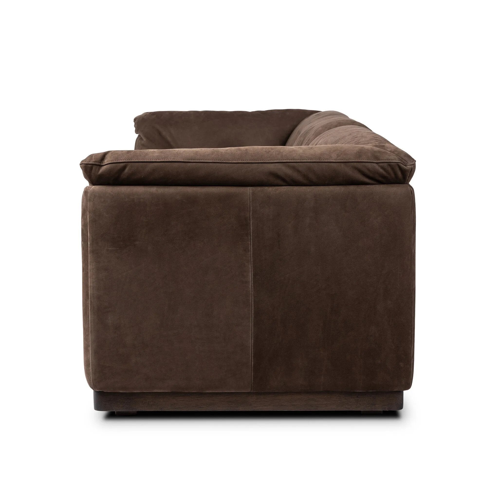 Inspired by 1970s Brutalism, this urban tuxedo sofa balances a rounded solid wood plinth with a curved seat deck and a relaxed, "wrinkled" upholstery design. Feather-blend cushions wrap the frame, finished with dramatic blind tufting for a hand-crafted, textural edge. Amethyst Home provides interior design, new home construction design consulting, vintage area rugs, and lighting in the Miami metro area.