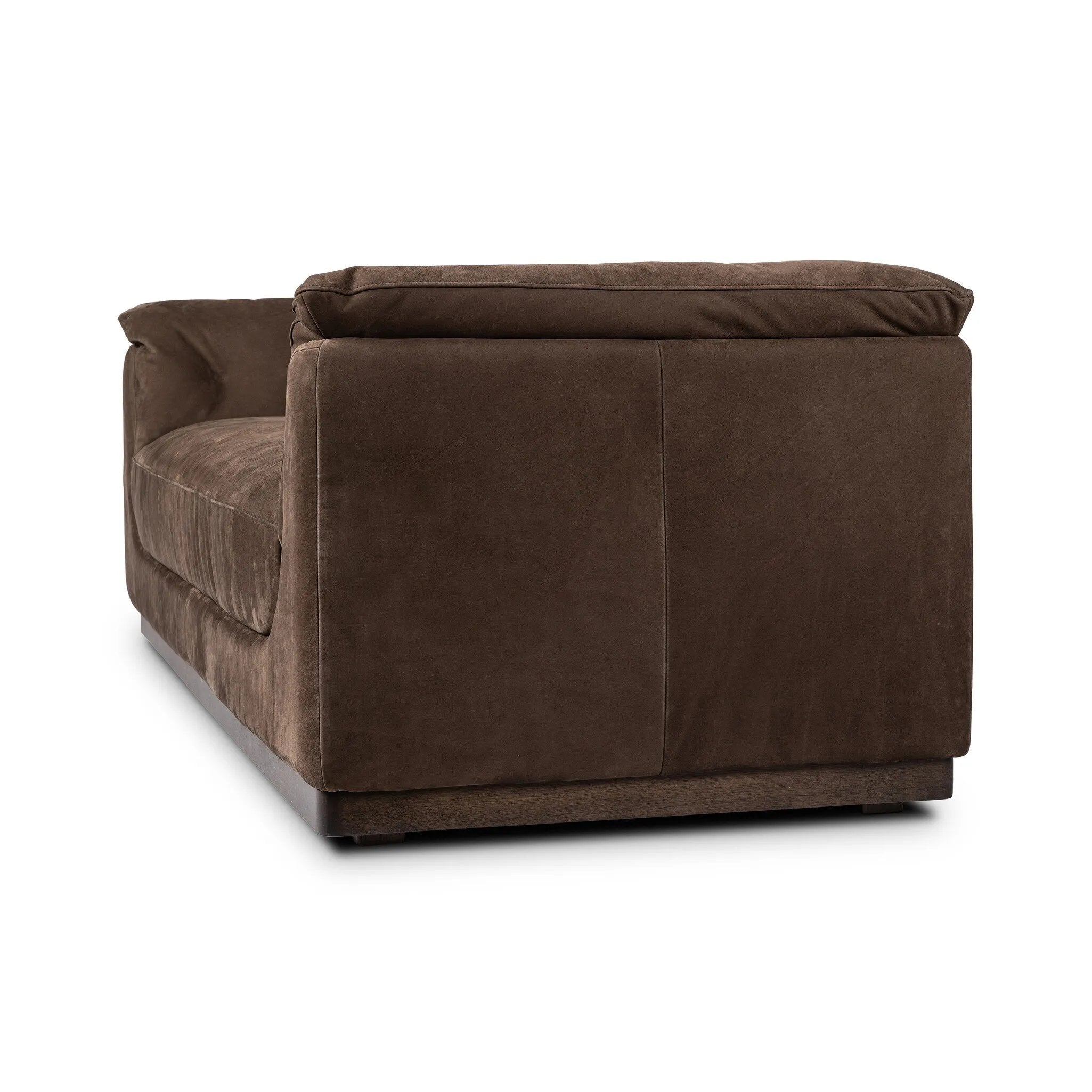 Inspired by 1970s Brutalism, this urban tuxedo sofa balances a rounded solid wood plinth with a curved seat deck and a relaxed, "wrinkled" upholstery design. Feather-blend cushions wrap the frame, finished with dramatic blind tufting for a hand-crafted, textural edge. Amethyst Home provides interior design, new home construction design consulting, vintage area rugs, and lighting in the Seattle metro area.