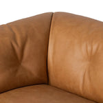 Inspired by 1970s Brutalism, this urban tuxedo sofa balances a rounded solid wood plinth with a curved seat deck and a relaxed, "wrinkled" upholstery design. Feather-blend cushions wrap the frame, finished with dramatic blind tufting for a hand-crafted, textural edge. Amethyst Home provides interior design, new home construction design consulting, vintage area rugs, and lighting in the Charlotte metro area.