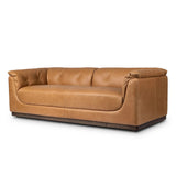 Inspired by 1970s Brutalism, this urban tuxedo sofa balances a rounded solid wood plinth with a curved seat deck and a relaxed, "wrinkled" upholstery design. Feather-blend cushions wrap the frame, finished with dramatic blind tufting for a hand-crafted, textural edge. Amethyst Home provides interior design, new home construction design consulting, vintage area rugs, and lighting in the Laguna Beach metro area.
