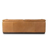 Inspired by 1970s Brutalism, this urban tuxedo sofa balances a rounded solid wood plinth with a curved seat deck and a relaxed, "wrinkled" upholstery design. Feather-blend cushions wrap the frame, finished with dramatic blind tufting for a hand-crafted, textural edge. Amethyst Home provides interior design, new home construction design consulting, vintage area rugs, and lighting in the Winter Garden metro area.