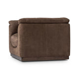 Inspired by 1970s brutalism, this urban swivel chair balances a rounded solid wood plinth with a curved seat deck and a relaxed, "wrinkled" upholstery design. Feather-blend cushions wrap the frame, finished with dramatic blind tufting for a hand-crafted, textural edge. Amethyst Home provides interior design, new home construction design consulting, vintage area rugs, and lighting in the Calabasas metro area.
