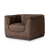 Inspired by 1970s brutalism, this urban swivel chair balances a rounded solid wood plinth with a curved seat deck and a relaxed, "wrinkled" upholstery design. Feather-blend cushions wrap the frame, finished with dramatic blind tufting for a hand-crafted, textural edge. Amethyst Home provides interior design, new home construction design consulting, vintage area rugs, and lighting in the Charlotte metro area.
