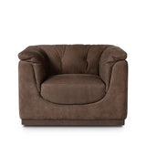 Inspired by 1970s brutalism, this urban swivel chair balances a rounded solid wood plinth with a curved seat deck and a relaxed, "wrinkled" upholstery design. Feather-blend cushions wrap the frame, finished with dramatic blind tufting for a hand-crafted, textural edge. Amethyst Home provides interior design, new home construction design consulting, vintage area rugs, and lighting in the Houston metro area.