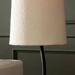 A curved cast iron tripod base pairs with an elongated boucle shade for a sculpted, minimalist look that works into any room with ease Amethyst Home provides interior design, new home construction design consulting, vintage area rugs, and lighting in the Salt Lake City metro area.
