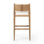 Unique materials make this bar stool a standout. A low, perfectly pitched backrest is made from wrapped paper cord and aged oak, for a natural, textured look. Simple squared seating is upholstered in high-performance fabric, perfect for entertaining. Amethyst Home provides interior design, new home construction design consulting, vintage area rugs, and lighting in the Dallas metro area.