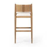 Unique materials make this bar stool a standout. A low, perfectly pitched backrest is made from wrapped paper cord and aged oak, for a natural, textured look. Simple squared seating is upholstered in high-performance fabric, perfect for entertaining. Amethyst Home provides interior design, new home construction design consulting, vintage area rugs, and lighting in the Dallas metro area.