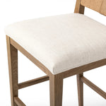 Unique materials make this bar stool a standout. A low, perfectly pitched backrest is made from wrapped paper cord and aged oak, for a natural, textured look. Simple squared seating is upholstered in high-performance fabric, perfect for entertaining. Amethyst Home provides interior design, new home construction design consulting, vintage area rugs, and lighting in the Houston metro area.