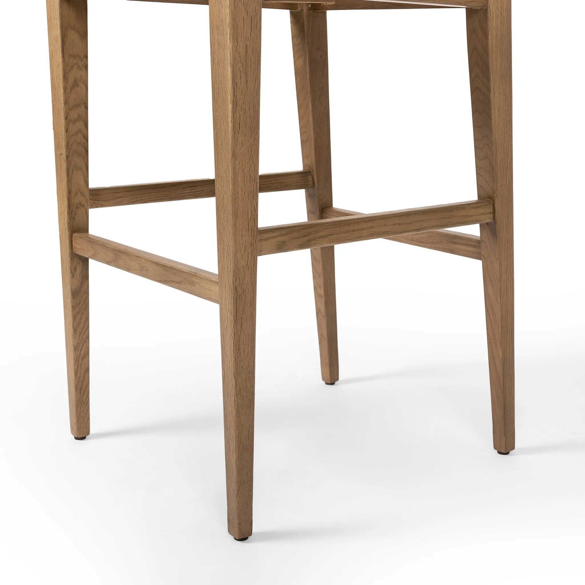 Unique materials make this bar stool a standout. A low, perfectly pitched backrest is made from wrapped paper cord and aged oak, for a natural, textured look. Simple squared seating is upholstered in high-performance fabric, perfect for entertaining. Amethyst Home provides interior design, new home construction design consulting, vintage area rugs, and lighting in the Kansas City metro area.