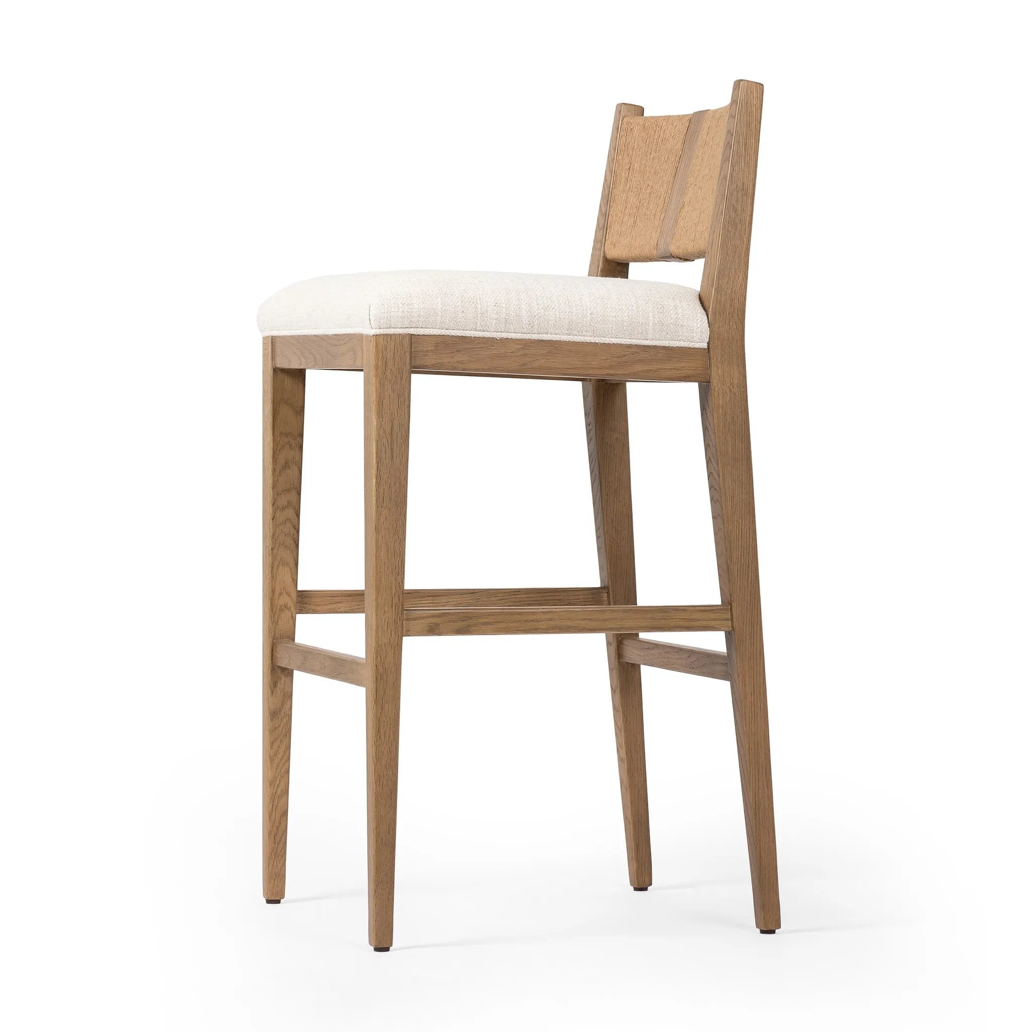 Unique materials make this bar stool a standout. A low, perfectly pitched backrest is made from wrapped paper cord and aged oak, for a natural, textured look. Simple squared seating is upholstered in high-performance fabric, perfect for entertaining. Amethyst Home provides interior design, new home construction design consulting, vintage area rugs, and lighting in the Los Angeles metro area.