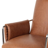 Shiny stainless steel frames tan top-grain leather cushioning for a balance of comfort and edge. Overfilled for a relaxed sit, the cushioned seat and back keep things supportive. Adjustable height and smooth 360-swivel bring ease to your workspace Amethyst Home provides interior design, new home construction design consulting, vintage area rugs, and lighting in the Portland metro area.