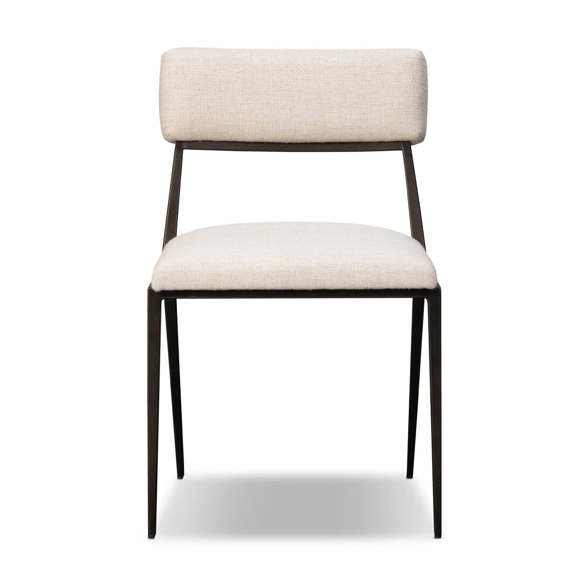 Bring a slim, light look to the dining room. This dining chair pairs cream performance fabric exclusive to Four Hands and bronzed iron to craft a simple, airy look. A tapered leg and decorative handle on the back elevate the look. Amethyst Home provides interior design, new home construction design consulting, vintage area rugs, and lighting in the Houston metro area.
