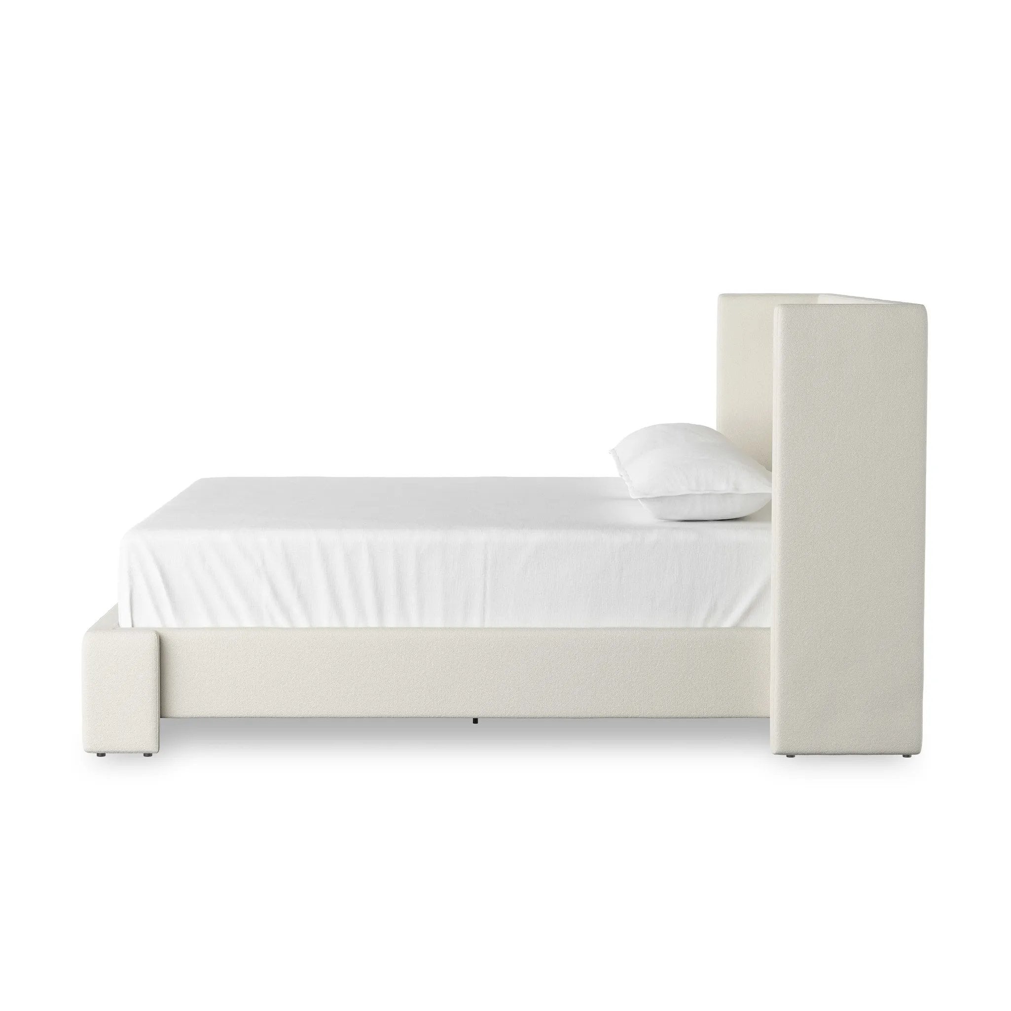 A shorter wingspan and geometric cutouts define this modern-day shelter wingback bed, designed for comfort from every angle. Upholstered in a cream fabric with subtle texture and a soft hand Amethyst Home provides interior design, new home construction design consulting, vintage area rugs, and lighting in the Alpharetta metro area.