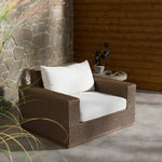 Featuring Suri Arashi Salt Outdoor Chair by Four Hands at Amethyst Home. Elevate your outdoors. A wide-format outdoor chair features a faux hyacinth frame and plinth base. Linear details and a boxy silhouette make this piece truly timeless, while a knife-edge back  cushion softens the whole look. Upholstered in 100% olefin, known for its UV-resistant, water-rep. Amethyst Home provides interior design, new home construction design consulting, vintage area rugs, and lighting in the Omaha metro area.