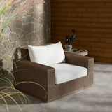 Featuring Suri Arashi Salt Outdoor Chair by Four Hands at Amethyst Home. Elevate your outdoors. A wide-format outdoor chair features a faux hyacinth frame and plinth base. Linear details and a boxy silhouette make this piece truly timeless, while a knife-edge back  cushion softens the whole look. Upholstered in 100% olefin, known for its UV-resistant, water-rep. Amethyst Home provides interior design, new home construction design consulting, vintage area rugs, and lighting in the Omaha metro area.