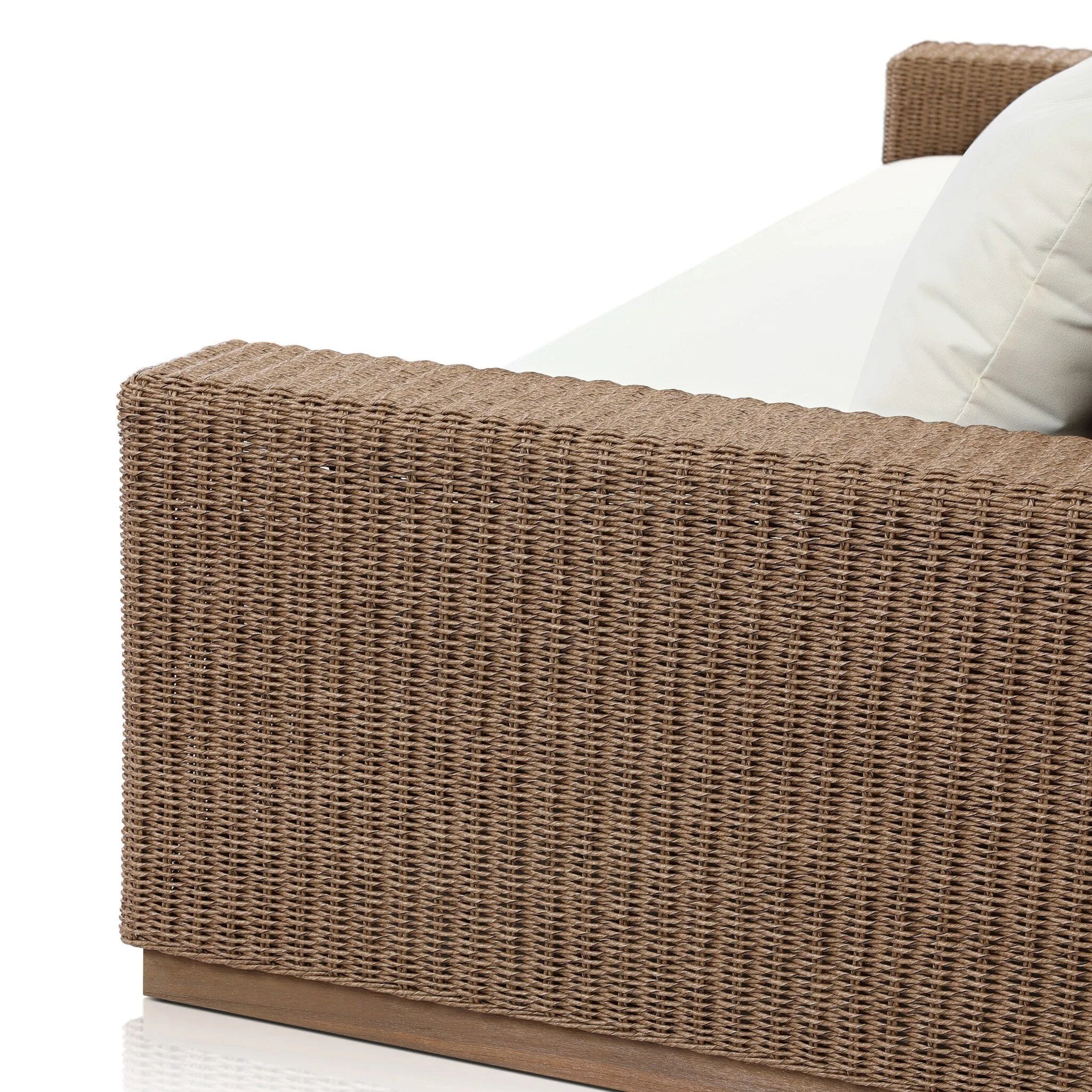 Elevate your outdoors. A wide-format outdoor sofa features a faux hyacinth frame and plinth base. Linear details and a boxy silhouette make this piece truly timeless, while knife-edge back cushions soften the whole look. Upholstered in 100% olefin, known for its UV-resistant, water-repellent and quick-drying abilities. Amethyst Home provides interior design, new home construction design consulting, vintage area rugs, and lighting in the Austin metro area.