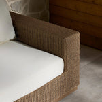 Elevate your outdoors. A wide-format outdoor sofa features a faux hyacinth frame and plinth base. Linear details and a boxy silhouette make this piece truly timeless, while knife-edge back cushions soften the whole look. Upholstered in 100% olefin, known for its UV-resistant, water-repellent and quick-drying abilities. Amethyst Home provides interior design, new home construction design consulting, vintage area rugs, and lighting in the Newport Beach metro area.