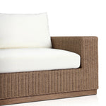 Elevate your outdoors. A wide-format outdoor sofa features a faux hyacinth frame and plinth base. Linear details and a boxy silhouette make this piece truly timeless, while knife-edge back cushions soften the whole look. Upholstered in 100% olefin, known for its UV-resistant, water-repellent and quick-drying abilities. Amethyst Home provides interior design, new home construction design consulting, vintage area rugs, and lighting in the Omaha metro area.
