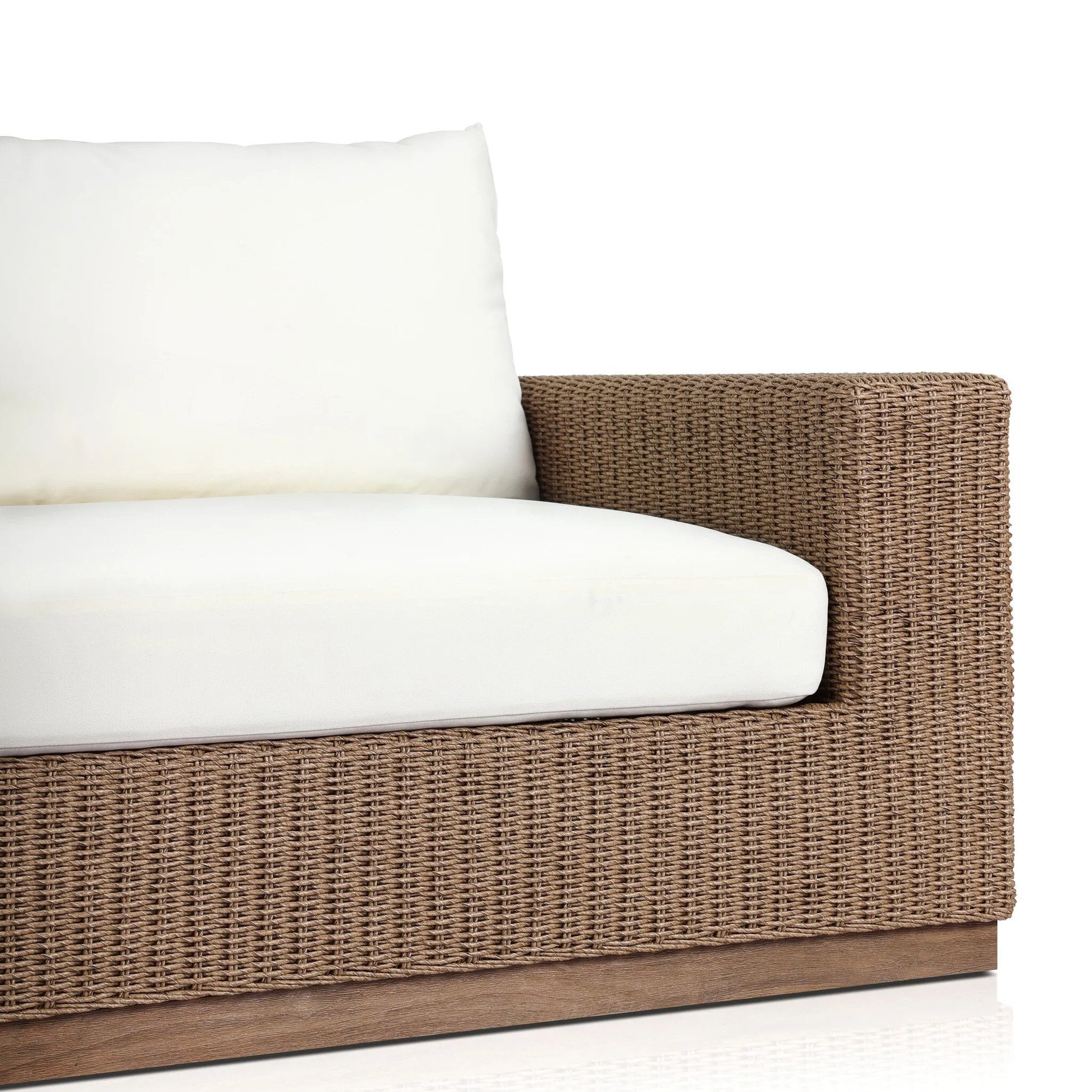 Elevate your outdoors. A wide-format outdoor sofa features a faux hyacinth frame and plinth base. Linear details and a boxy silhouette make this piece truly timeless, while knife-edge back cushions soften the whole look. Upholstered in 100% olefin, known for its UV-resistant, water-repellent and quick-drying abilities. Amethyst Home provides interior design, new home construction design consulting, vintage area rugs, and lighting in the Omaha metro area.