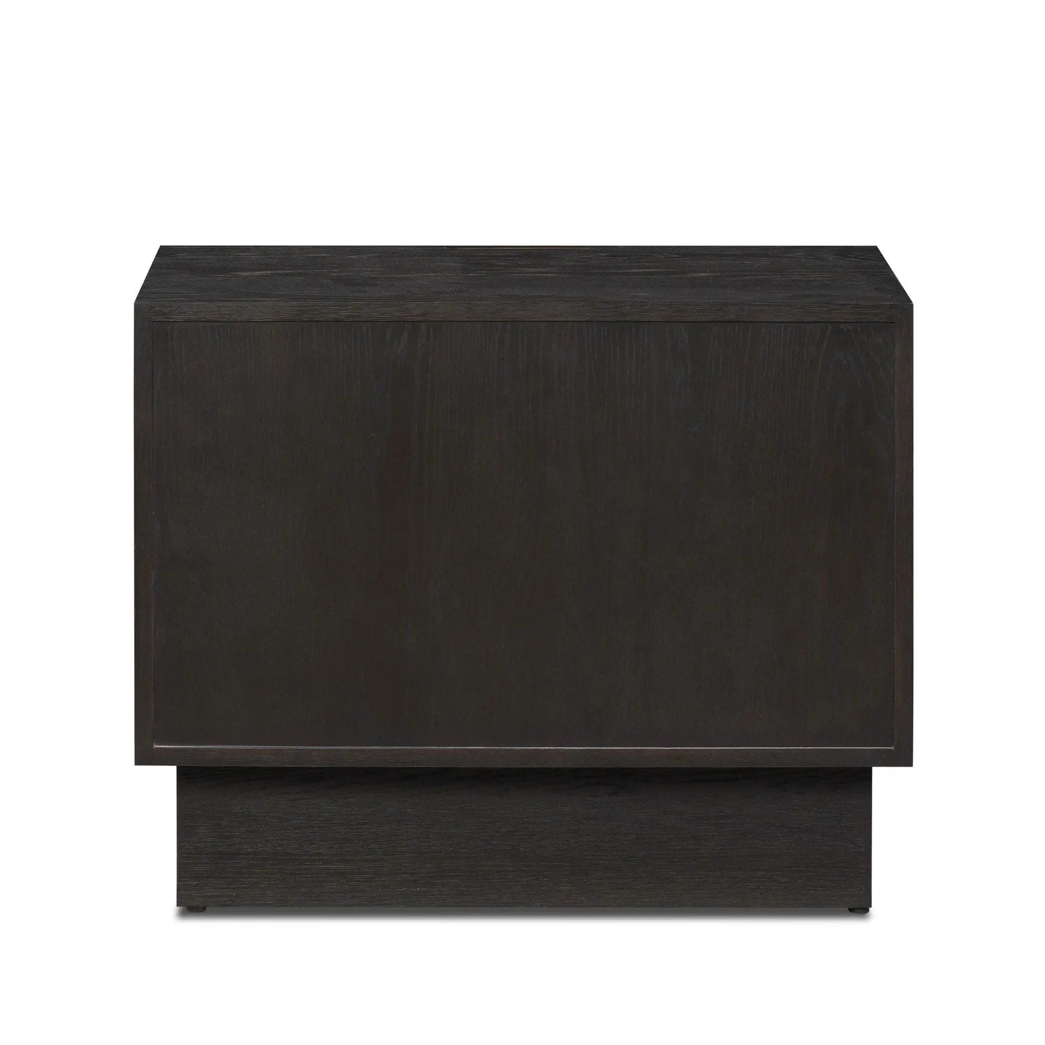 A softened Brutalist take on the traditional nightstand. The monolithic piece’s black oak veneer case sits atop a matching pedestal for an element of exaggeration. A grid pattern with inflated volume adds drama.As enthusiasts of luxe materials at Amethyst, we love the warm modern inspired Swell Nightstand - Dry Black Oak Veneer. Amethyst Home provides interior design, new home construction design consulting, vintage area rugs, and lighting in the Boston metro area.