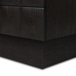 A softened Brutalist take on the traditional nightstand. The monolithic piece’s black oak veneer case sits atop a matching pedestal for an element of exaggeration. A grid pattern with inflated volume adds drama.As enthusiasts of luxe materials at Amethyst, we love the warm modern inspired Swell Nightstand - Dry Black Oak Veneer. Amethyst Home provides interior design, new home construction design consulting, vintage area rugs, and lighting in the Dallas metro area.