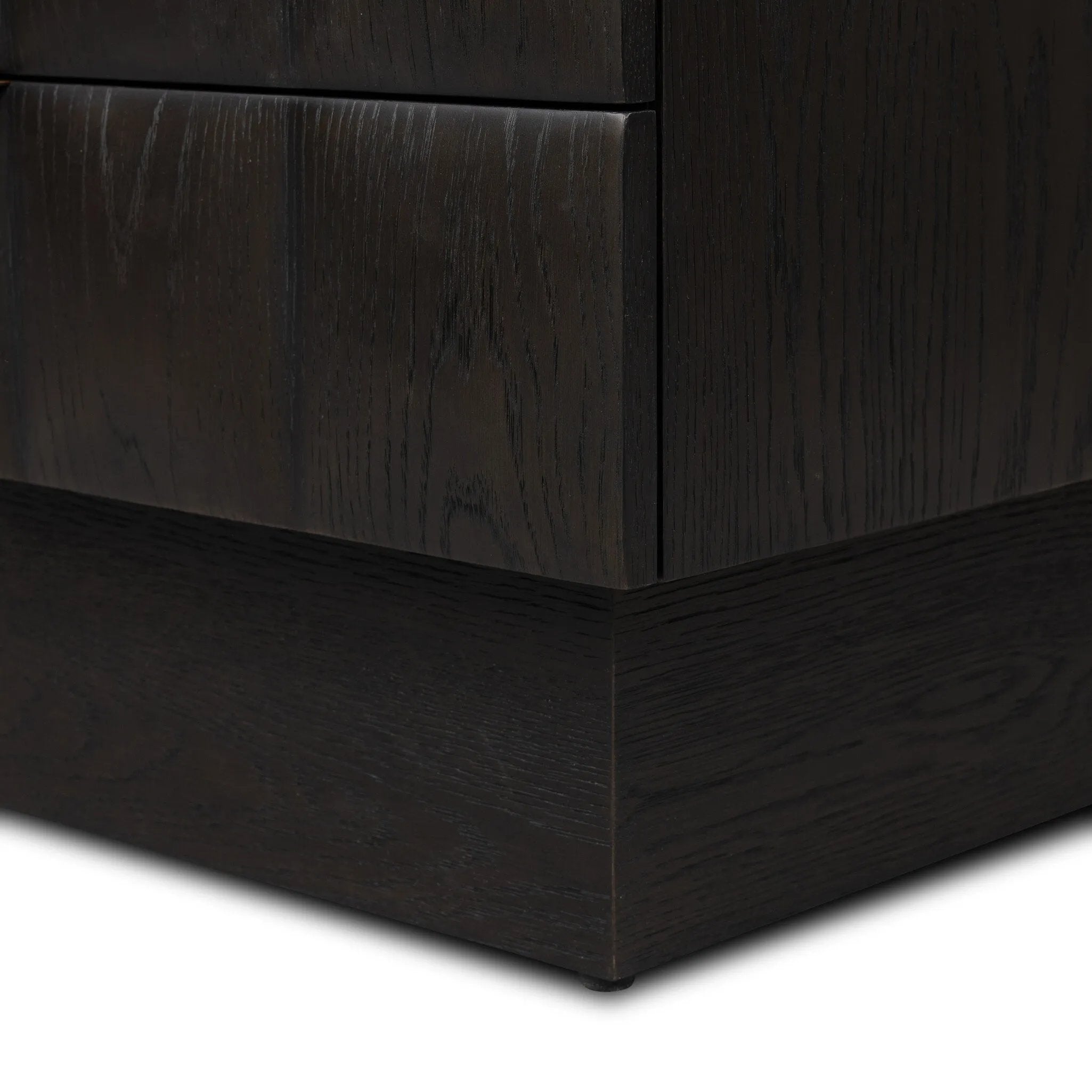A softened Brutalist take on the traditional nightstand. The monolithic piece’s black oak veneer case sits atop a matching pedestal for an element of exaggeration. A grid pattern with inflated volume adds drama.As enthusiasts of luxe materials at Amethyst, we love the warm modern inspired Swell Nightstand - Dry Black Oak Veneer. Amethyst Home provides interior design, new home construction design consulting, vintage area rugs, and lighting in the Dallas metro area.