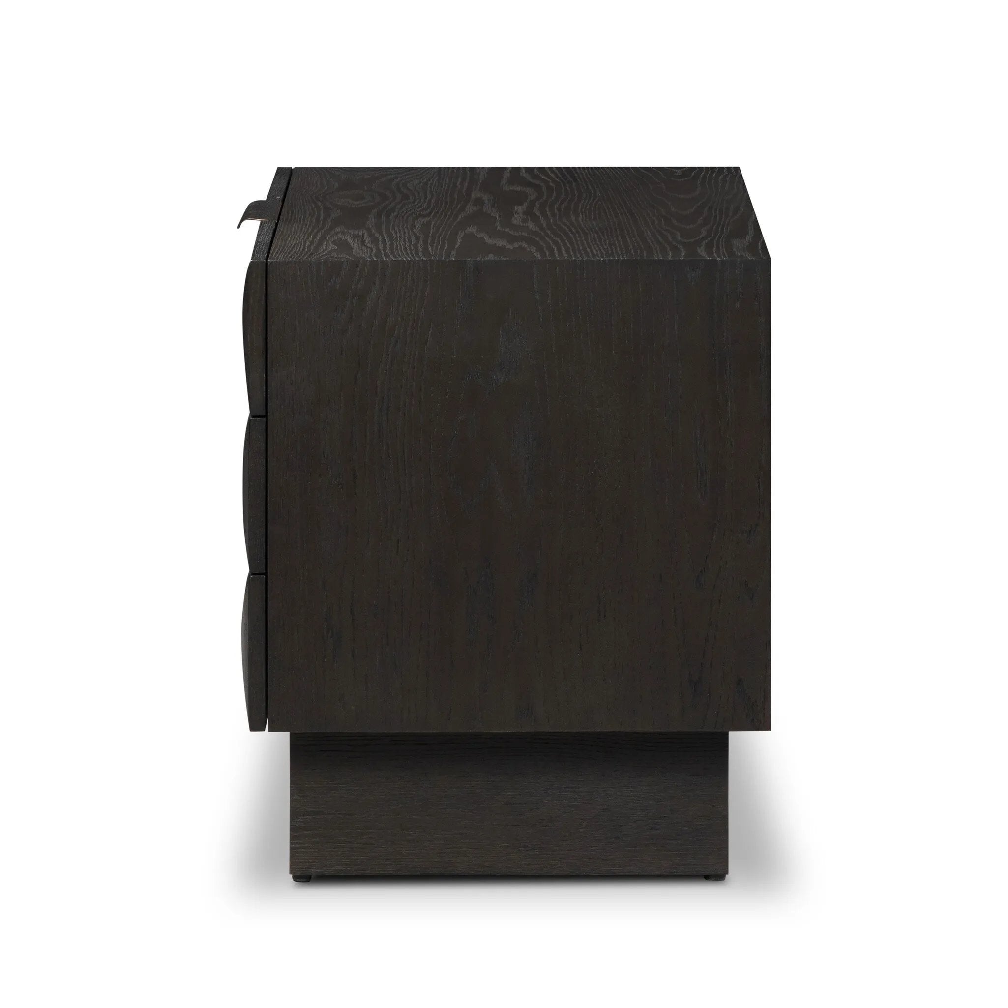 A softened Brutalist take on the traditional nightstand. The monolithic piece’s black oak veneer case sits atop a matching pedestal for an element of exaggeration. A grid pattern with inflated volume adds drama.As enthusiasts of luxe materials at Amethyst, we love the warm modern inspired Swell Nightstand - Dry Black Oak Veneer. Amethyst Home provides interior design, new home construction design consulting, vintage area rugs, and lighting in the Newport Beach metro area.