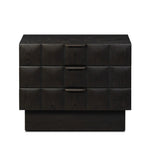 A softened Brutalist take on the traditional nightstand. The monolithic piece’s black oak veneer case sits atop a matching pedestal for an element of exaggeration. A grid pattern with inflated volume adds drama.As enthusiasts of luxe materials at Amethyst, we love the warm modern inspired Swell Nightstand - Dry Black Oak Veneer. Amethyst Home provides interior design, new home construction design consulting, vintage area rugs, and lighting in the Scottsdale metro area.