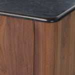 Design your space with hallmark features inspired by soft Brutalism. Made from solid walnut and poplar woods with a natural finish, the cabinet is topped with a black marble top with half bullnose edging for smooth contours. Double doors open to two shelves for ample storage. High-quality hardware is crafted from black iron. Amethyst Home provides interior design, new home construction design consulting, vintage area rugs, and lighting in the Alpharetta metro area.