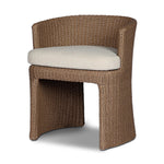 This outdoor dining chair takes on a curved silhouette, crafted from woven faux hyacinth and complemented by a heavily textured boucle cushion. Cover or store inside during inclement weather and when not in use.As lovers of natural materials at Amethyst, we love the designer inspired Thora Outdoor Dining Chair - Vada Cream. Amethyst Home provides interior design, new home construction design consulting, vintage area rugs, and lighting in the Miami metro area.