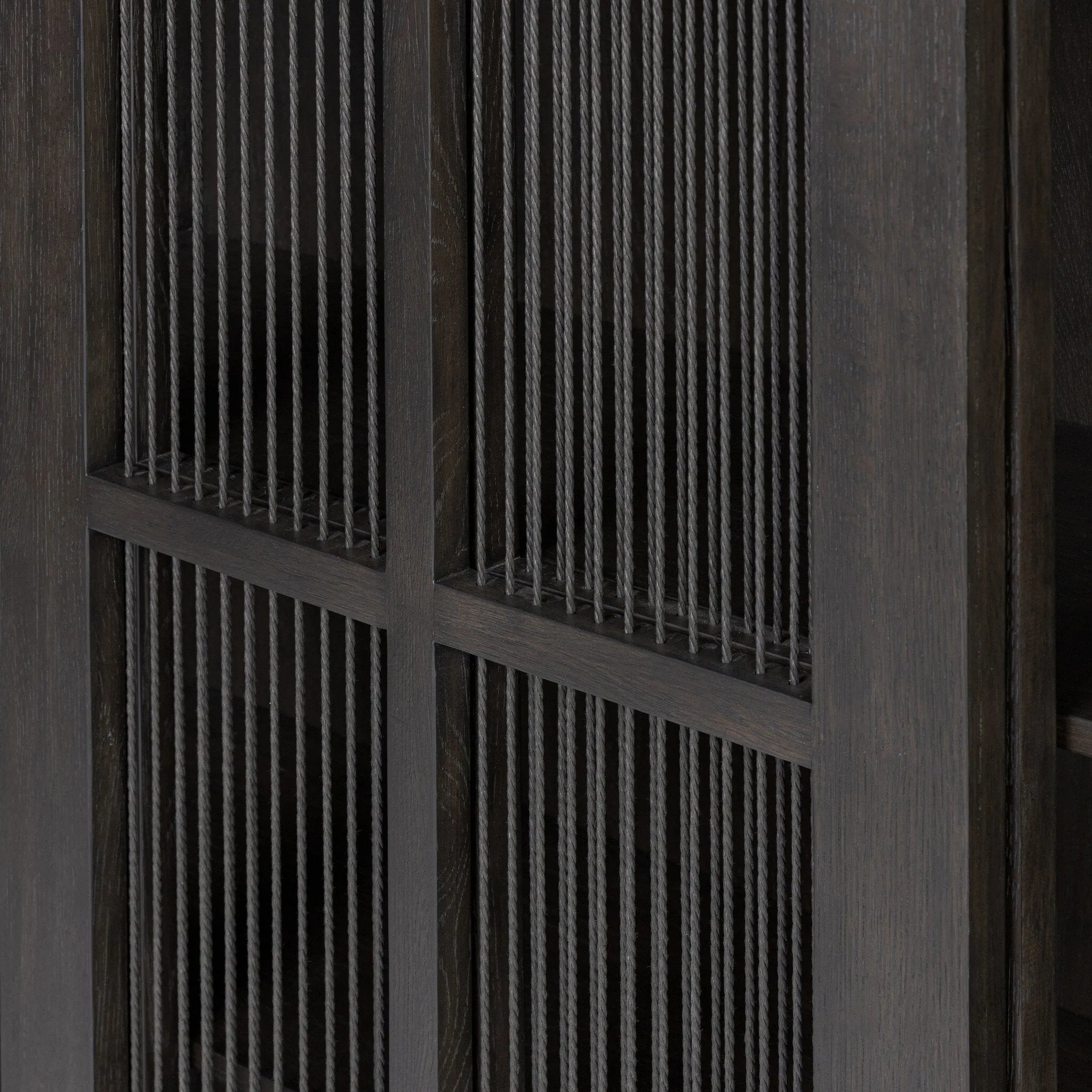 Long sliding doors with paper cord stripes inspired by Japanese teahouses bring a traditional look to this spacious cabinet. Made from oak in a smoked black finish, with a slightly oversized top.As lovers of luxe aesthetics at Amethyst, we love the optimistic inspired Tuscola Cabinet. Amethyst Home provides interior design, new home construction design consulting, vintage area rugs, and lighting in the Miami metro area.